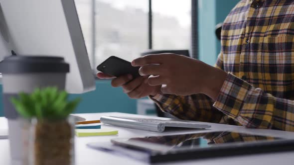 Mixed race man using phone at the office