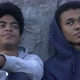 Two African-American homeless teen boys sitting on street - VideoHive Item for Sale