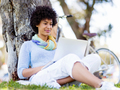 Woman working outdoors in a meadow with laptop - PhotoDune Item for Sale