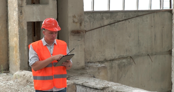 Worker With a Walkie-talkie At a Construction Site