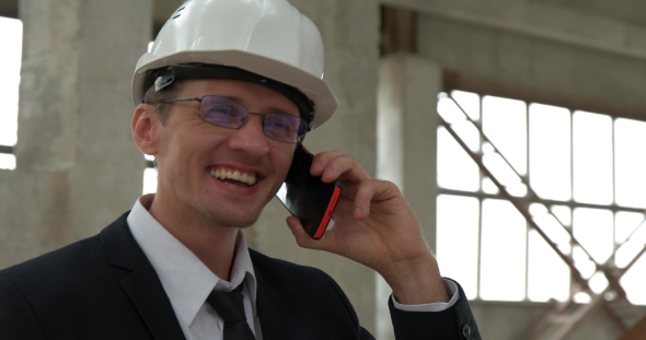 Chief Talking on the Phone at the Construction Site