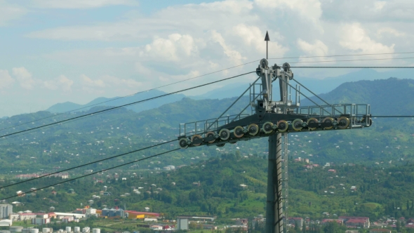 Funicular Cable Car In The Summer In The Mountains. Cabs Passes a Beautiful Cloudy Sky