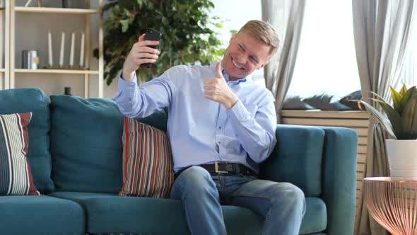 Middle Aged Man Taking Selfie While Sitting on Couch Photograph