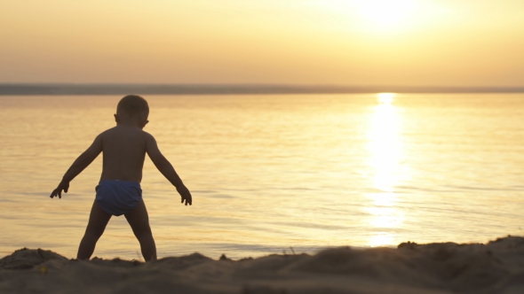 Little Boy On Beach At Sunset
