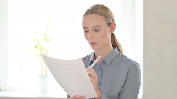Portrait of Woman Reading Documents