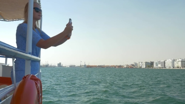 Girl Travels By Boat In Sea Of City Thessaloniki, Greece And Photographed Seascape