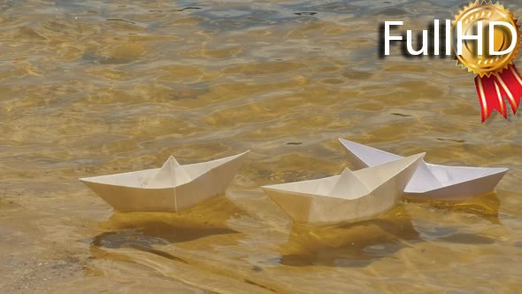 Three White Paper Ships Are Floating by Water