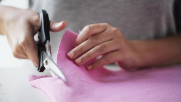 Woman With Tailor Scissors Cutting Out Fabric 40