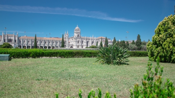 The Jeronimos Monastery Or Hieronymites Monastery With Lawn And Bushes Is Located In Lisbon