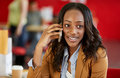 Confident female designer talking on a mobile phone in red creat - PhotoDune Item for Sale