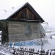 Snow Is On The Background Of The Wooden Old House. - VideoHive Item for Sale