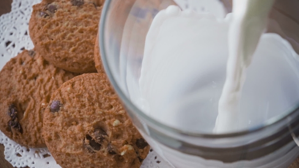 Pouring Glass Of Milk And Cookies