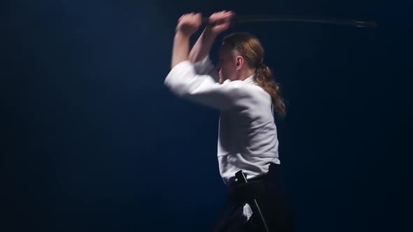 Man Fighting at Aikido Training with Japanese Sword Katana in Martial Arts School. Healthy Lifestyle