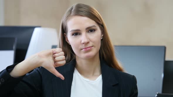 Thumbs Down by Woman in Office