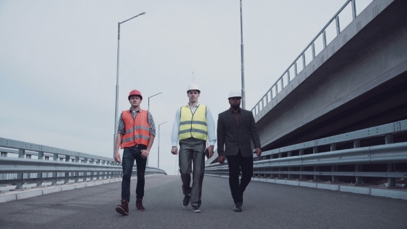 Construction Engineers Walking On Highway Ramp