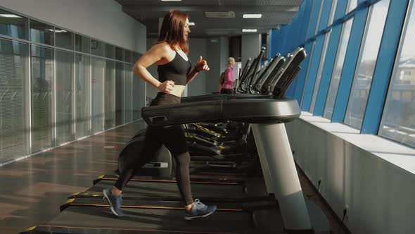 Fitness Woman Running on Treadmill in Gym Having Cardio Training