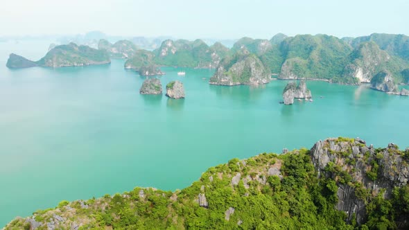 Aerial: flying over Ha Long Bay rock pinnacles, famous tourism destination in Vietnam