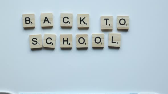 Back to School Wooden Letters on White Background and Moving Facial Protective Mask with Colorful