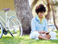 Young woman using tablet in the park. - PhotoDune Item for Sale