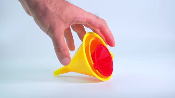 The hand picks up the Funnel for pouring water