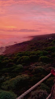 Women Watching Sunset Over the Ocean in Front of Their Lodge During Vacation in South Africa