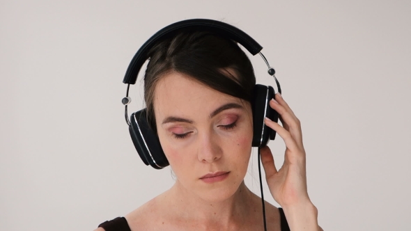 Woman with Headphones Swaying and Smiling