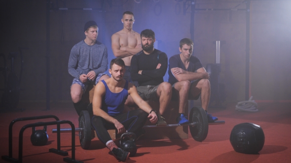 Team Of Crossfit Athletes Looking Into The Camera And Wiggles His Head.