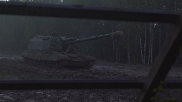 Self-propelled Artillery Unit On The Road In a Forest