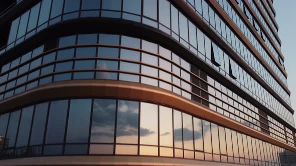 Slow camera movement upwards along a modern glass building.