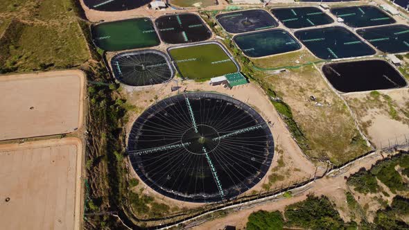 Massive pond shrimp farms on Vietnam coastline, aerial orbit shot