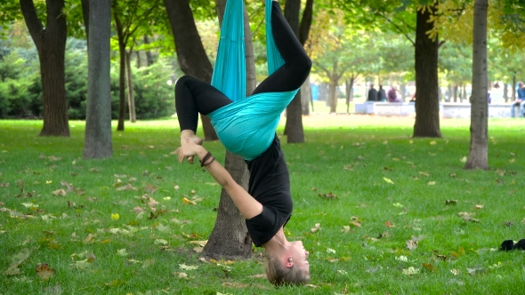 Girl In a Park Engaged In Aerial Yoga