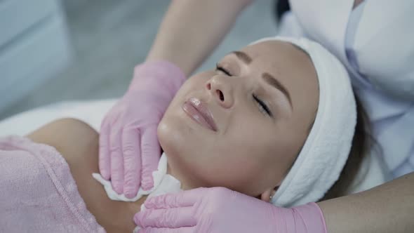 Close View of Cleaning the Skin of Woman's Face with Wipes in Cosmetology Clinic