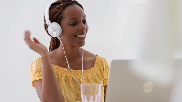 Young Woman in Headphones Talk and Gesture in Video Call