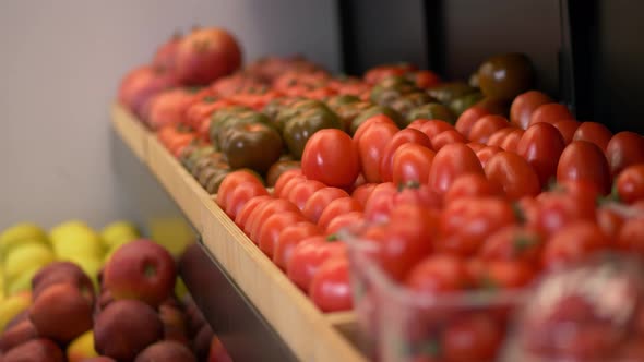 Hands of Female Worker Putting Tomatoes on Shelf