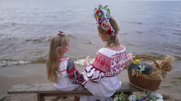 Back View Relaxed Ukrainian Young Mother and Little Daughter in Traditional Dresses Holding Hands