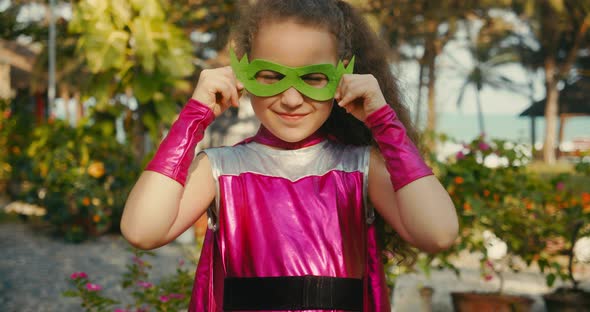 Beautiful Baby Girl in the Superhero Costume Kid Plays Superhero Child Dressed in a Pink Cloak