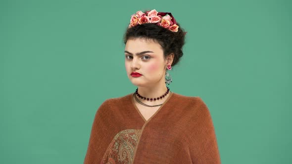 Beautiful Portrait of Woman with Thick Eyebrows Frida Kahlo Lookalike Wearing Jewelry and Roses in