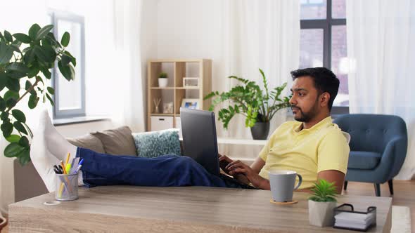 Tired Man with Laptop Working at Home Office