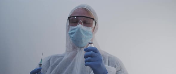 Woman lowering down a vaccine bottle and syringe