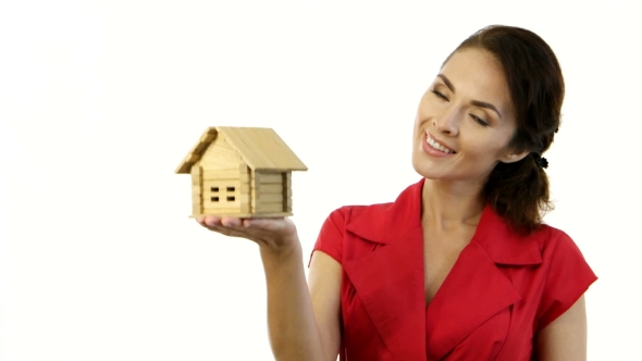 Happy Woman Holding a Little House In Her Hands