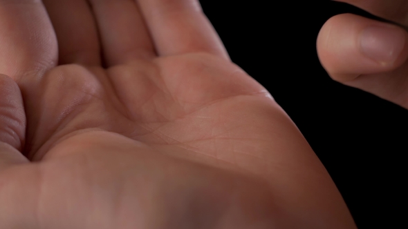 Man's Hand Taking Out Pills From Blister Pack Isolated On Black