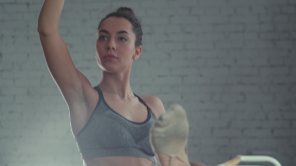 Ballet Dancer Doing Stretching. Leg At The Ballet Bar.