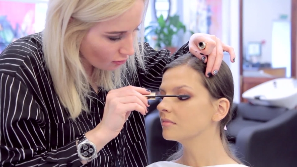 Professional Make-up Artist Applying Mascara To Model