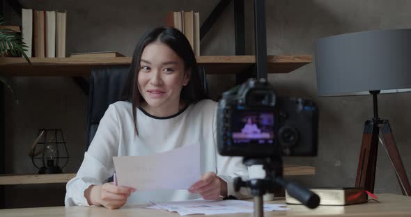 Asian Woman with Camera Recording Video at Modern Office