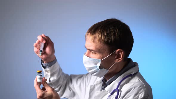 Male Doctor Draws Up COVID Vaccine Syringe