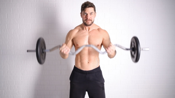 Strong Topless Man Doing Exercise With Dumbbells