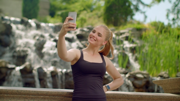 Young Woman Taking Selfie In Park. Selfie Woman. Woman Selfie