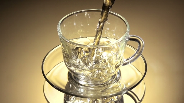 Tea Being Poured Into Glass Tea Cup