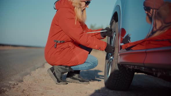 Woman Check Car Tire Pressure. Vehicle Trouble On Road On Vacation Trip. Female Trying Fix Car Tire.