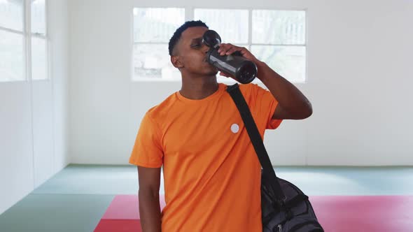 Mixed race man drinking water